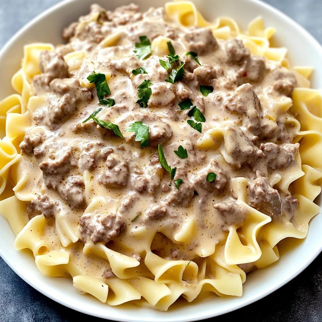 Plate of creamy ground beef stroganoff served over egg noodles