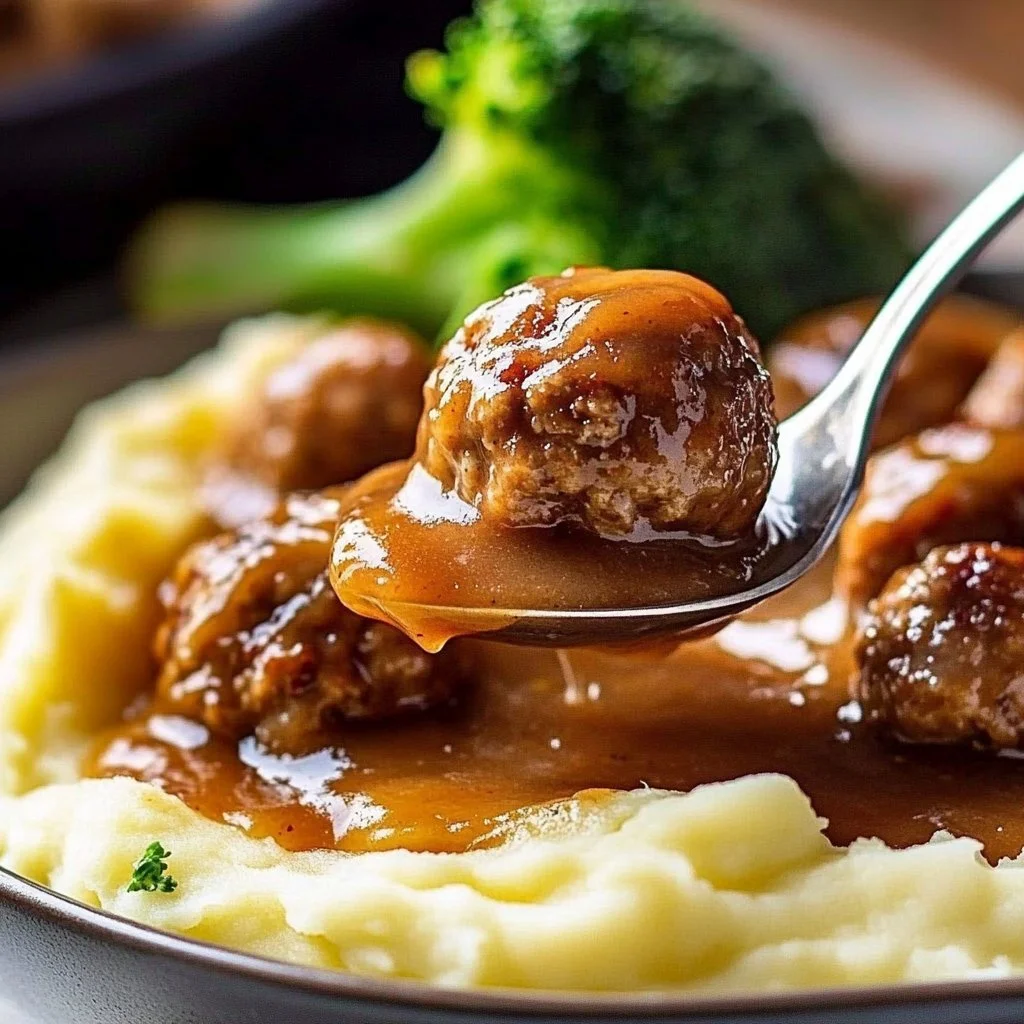 Plate of Salisbury meatballs and mashed potatoes garnished with parsley.