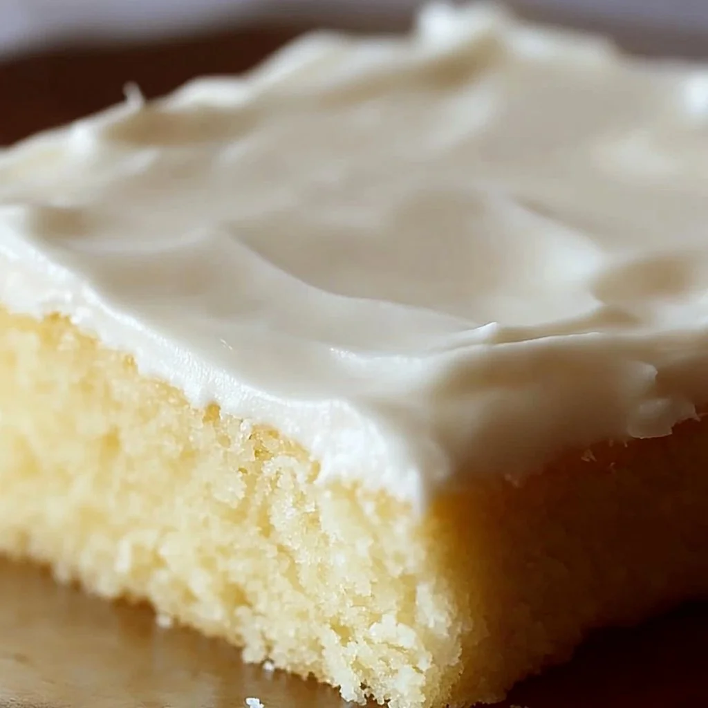 Delicious White Texas Sheet Cake with creamy frosting on a rustic table