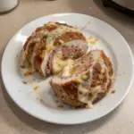 Chicken Cordon Bleu Meatloaf garnished with herbs on a plate