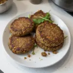 Delicious homemade lentil burger served with fresh vegetables and sauce.