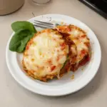 Baked Zucchini Parmesan with golden cheese and fresh basil
